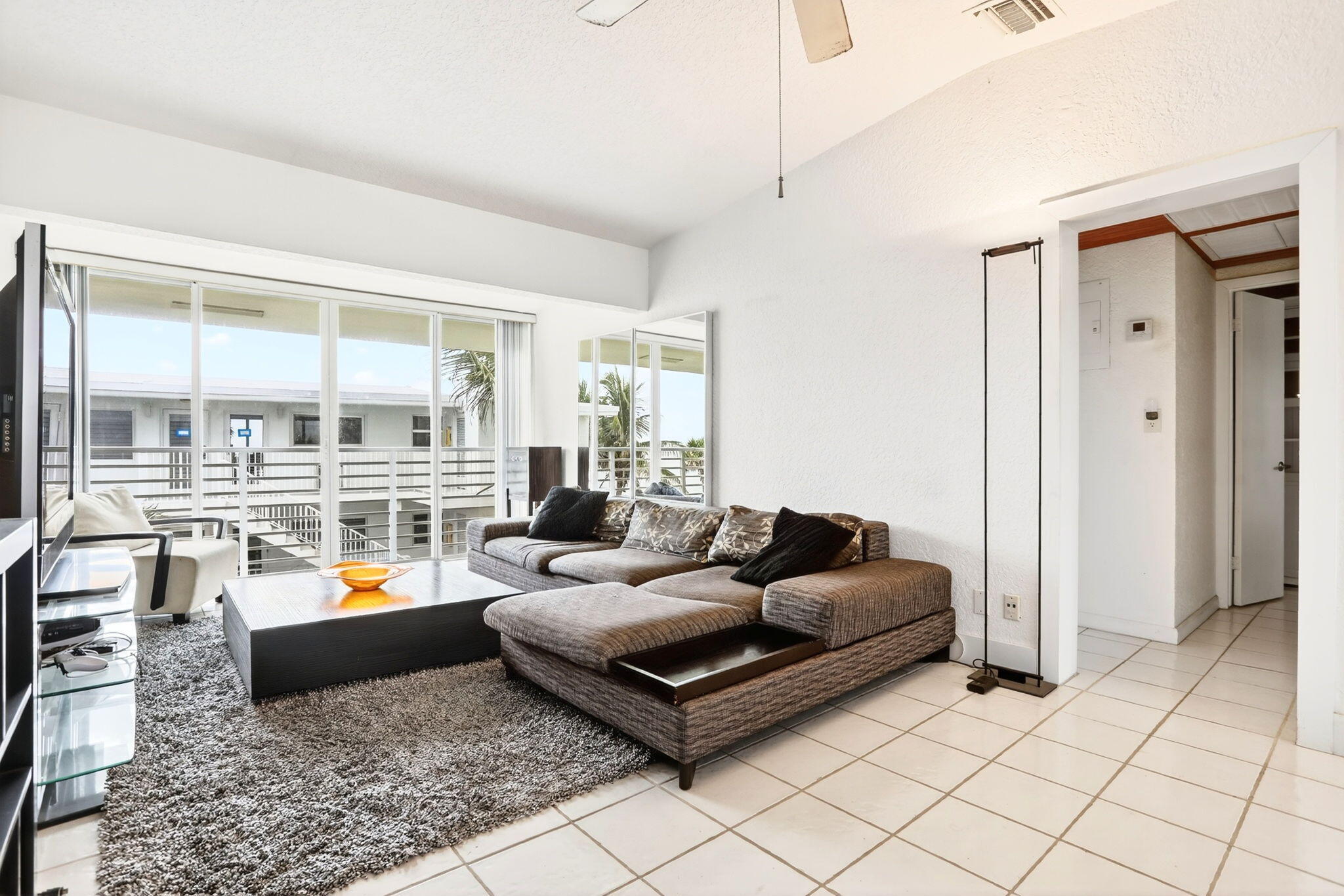 1043 Hillsboro Mile, Unit 22C Hillsboro Beach, FL 33062 - Photo 10 of 53 a living room with furniture and floor to ceiling windows