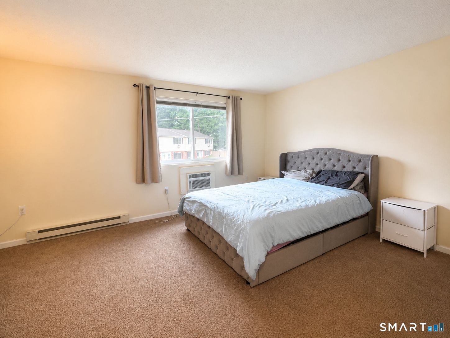 461 Spring Street, Unit 1A Naugatuck, CT 06770 - Photo 14 of 17 a spacious bedroom with a bed and a window