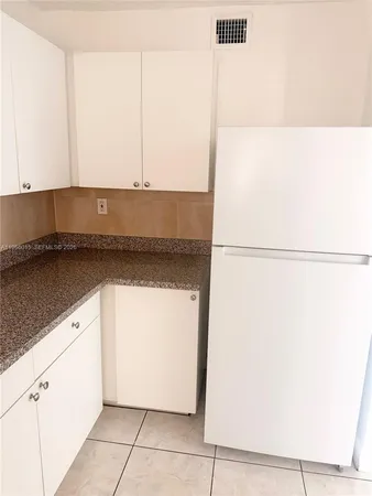 a kitchen with a sink and a refrigerator