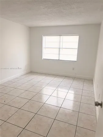 a view of an empty room and a window