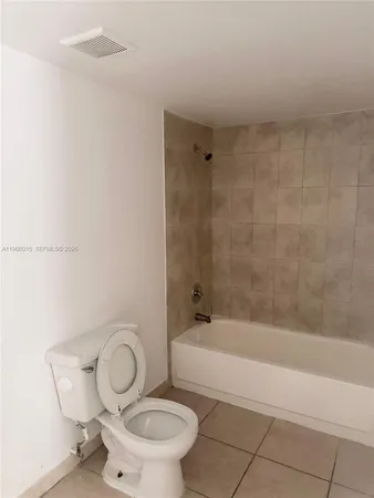 a bathroom with a toilet and a bathtub