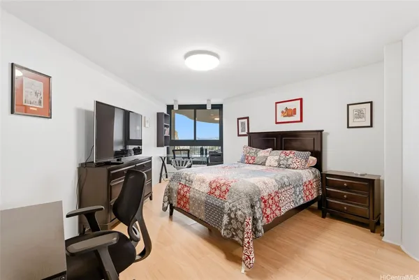 a bedroom with a bed window and chair