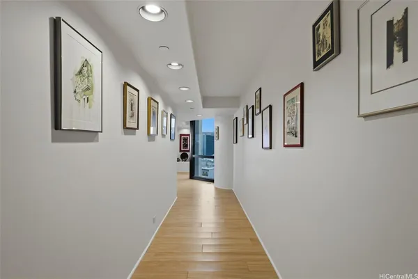 a view of a hallway with paintings on the wall