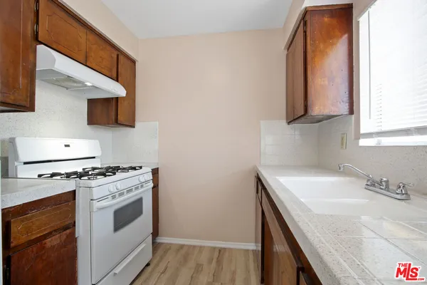 a kitchen with a sink stove and microwave
