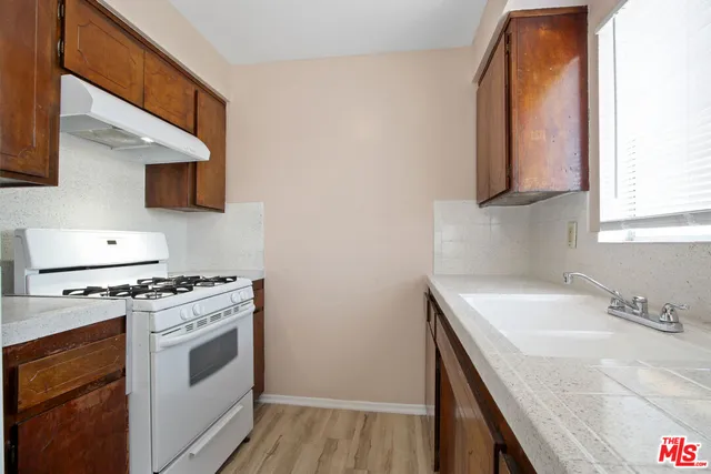 a kitchen with a sink stove and microwave