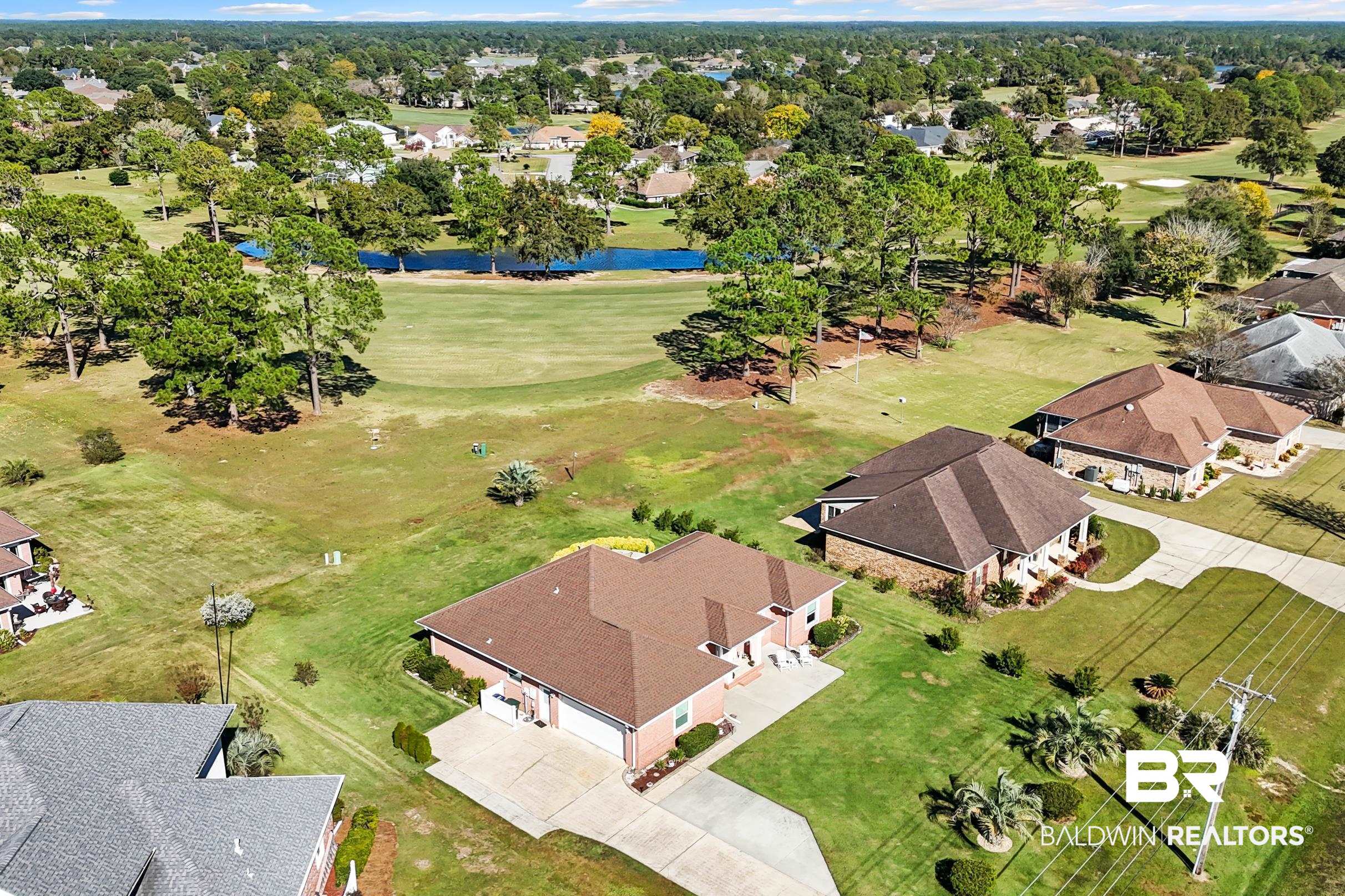22355 East County Road 12 Foley, AL 36535 - Photo 53 of 54 Aerial view of residential area with a large body of water and a local golf course
