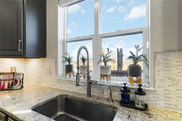 a kitchen with a faucet a sink and cabinets
