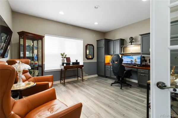 a living room with furniture and a gym equipment