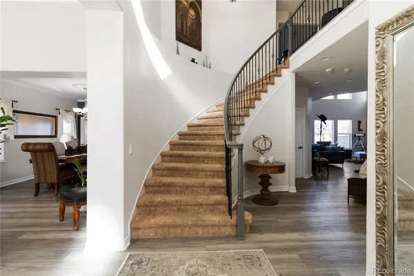 a view of entryway and hall with wooden floor
