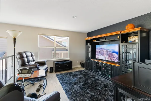 a room with furniture workspace and a flat screen tv
