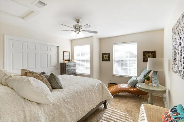 a bedroom with a bed couch and window