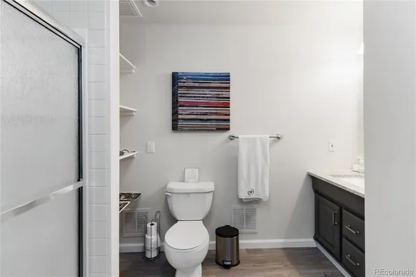 a bathroom with a toilet and a shower