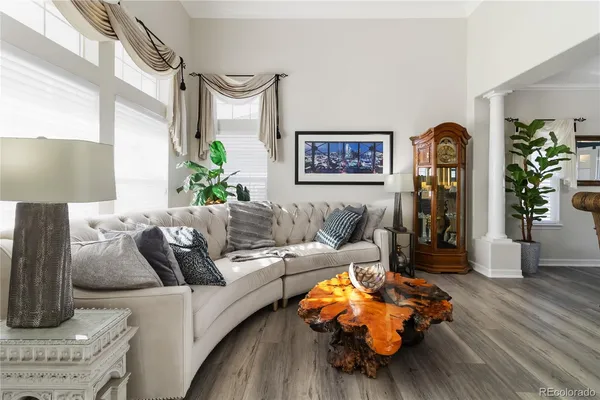a living room with furniture and wooden floor