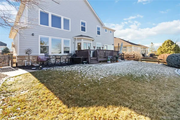 a view of a house with a yard covered in snow