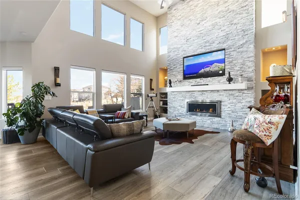 a living room with furniture a flat screen tv and a fireplace