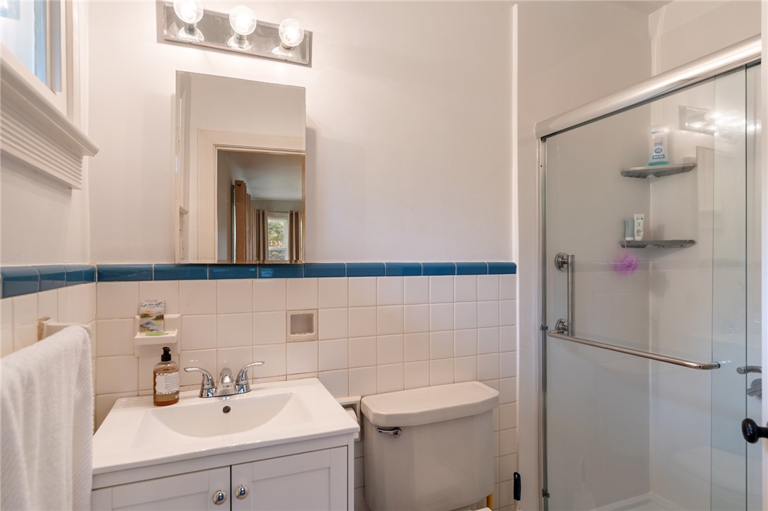 1105 Greenacres Anderson, SC 29621 - Photo 22 of 46 Functional full bathroom featuring a glass-enclosed shower, a sleek vanity, and tiled walls.