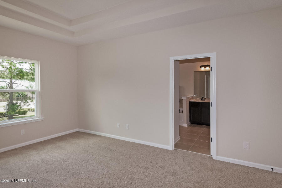 1708 Sanctuary Way Fleming Island, FL 32003 - Photo 17 of 21 an empty room with windows and closet