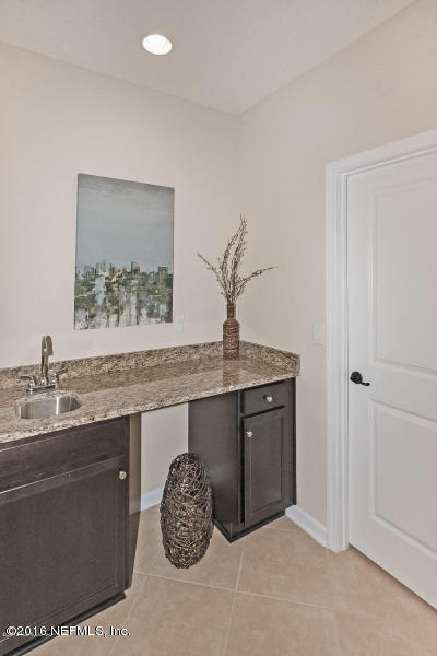 1708 Sanctuary Way Fleming Island, FL 32003 - Photo 21 of 21 a room with a sink and a mirror