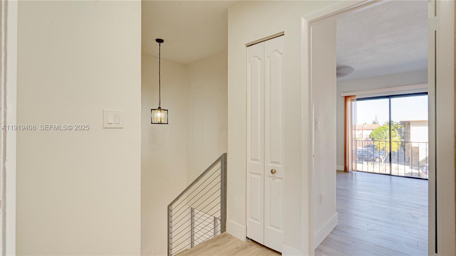710 Southwest 114th Avenue, Unit C3 Sweetwater, FL 33174 - Photo 13 of 25 a view of a hallway with wooden floor and a bathroom