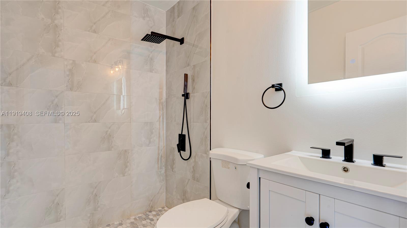 710 Southwest 114th Avenue, Unit C3 Sweetwater, FL 33174 - Photo 14 of 25 a bathroom with a sink toilet and shower