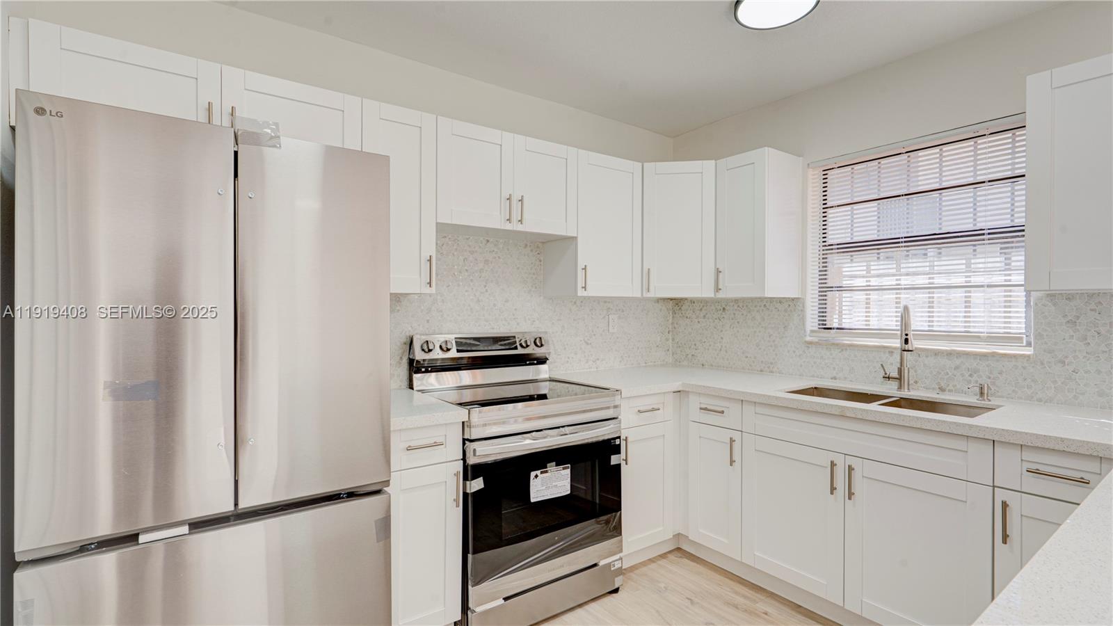 710 Southwest 114th Avenue, Unit C3 Sweetwater, FL 33174 - Photo 5 of 25 a kitchen with a white cabinets and white appliances