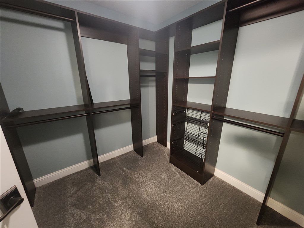 7441 Dodson Road Brookville, OH 45309 - Photo 21 of 50 This spacious walk-in closet features ample shelving and hanging space for effortless organization.