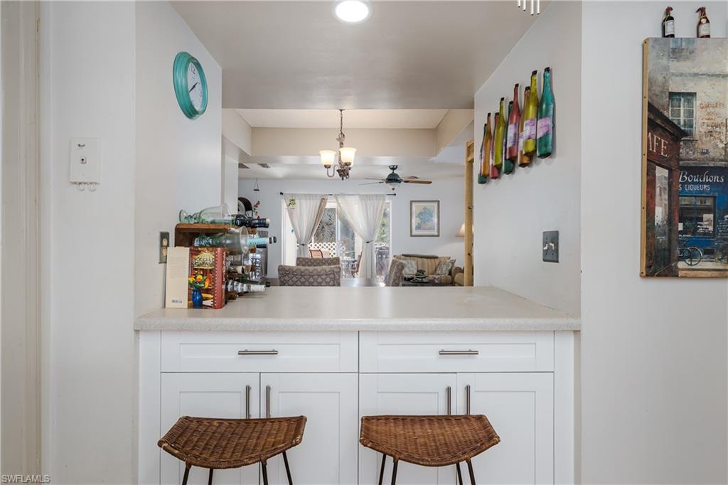 20 Watercolor Way Naples, FL 34113 - Photo 12 of 44 a kitchen with cabinets and a wooden floor