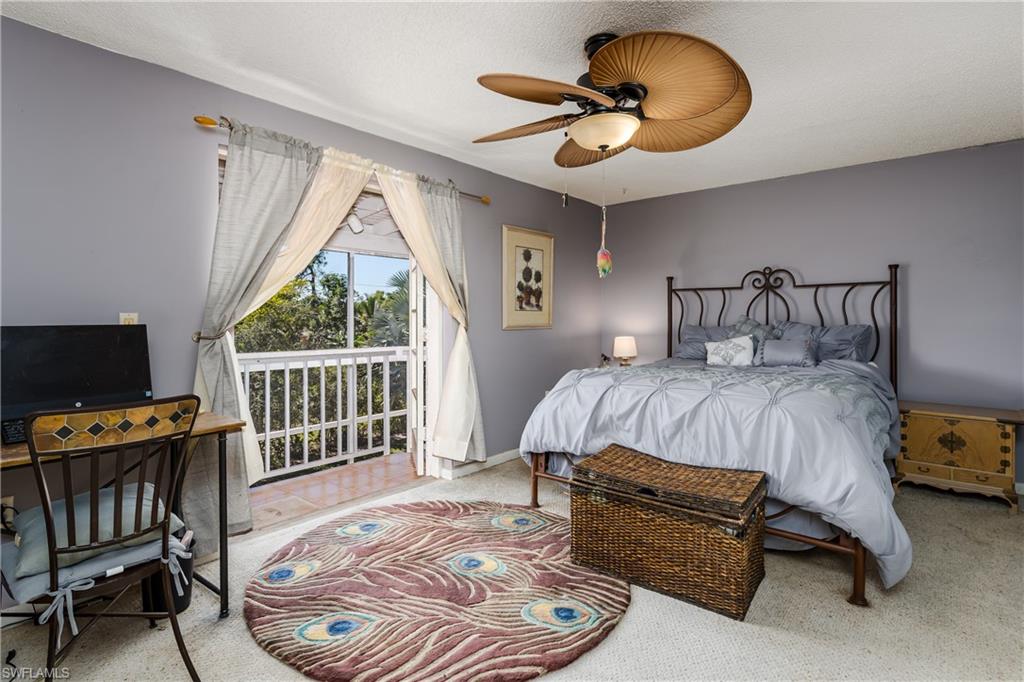 20 Watercolor Way Naples, FL 34113 - Photo 13 of 44 a bedroom with a bed a chandelier and a window