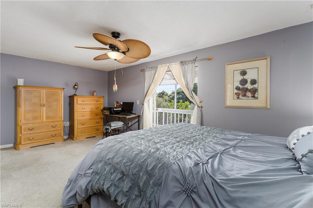 20 Watercolor Way Naples, FL 34113 - Photo 14 of 44 a bedroom with a bed and a large window