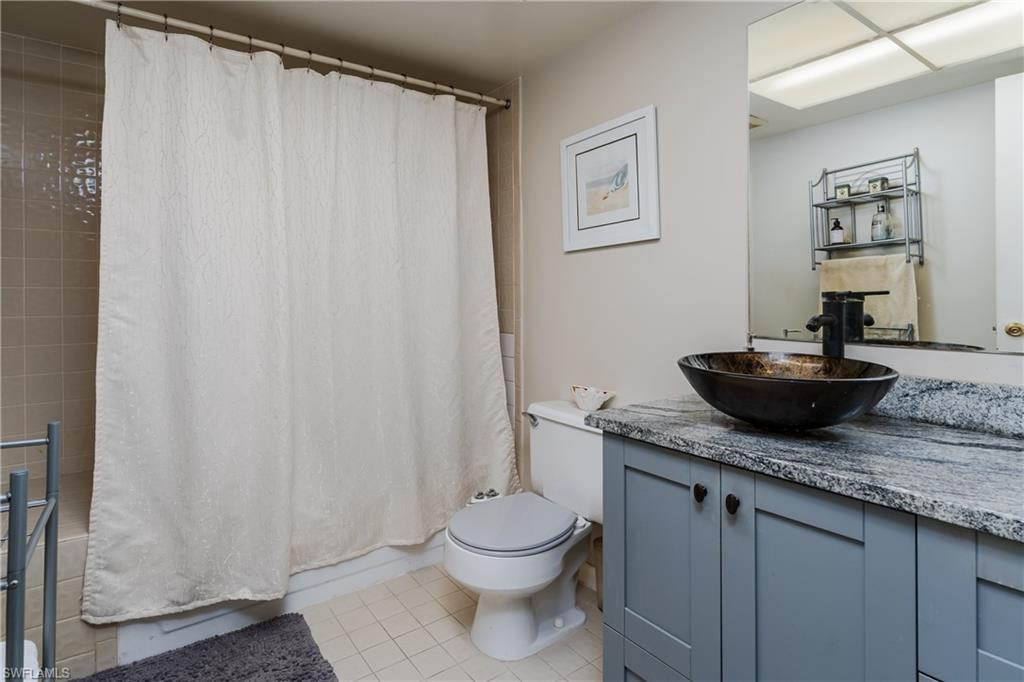20 Watercolor Way Naples, FL 34113 - Photo 16 of 44 a bathroom with a granite countertop sink and a mirror