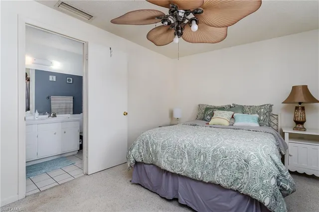 a bedroom with a bed and chandelier