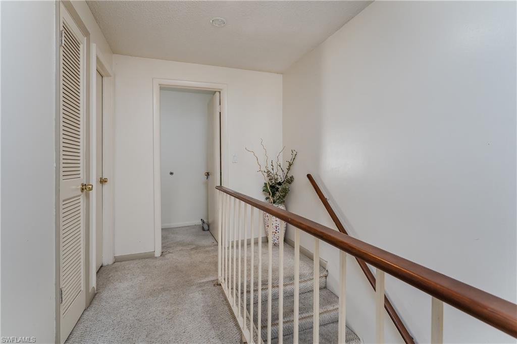 20 Watercolor Way Naples, FL 34113 - Photo 21 of 44 a view of a hallway with wooden floor and staircase