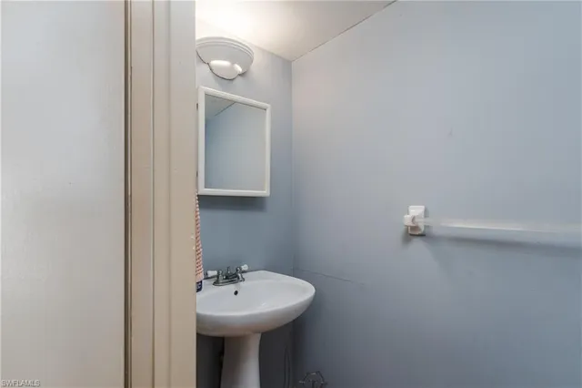 a bathroom with a sink a mirror and vanity