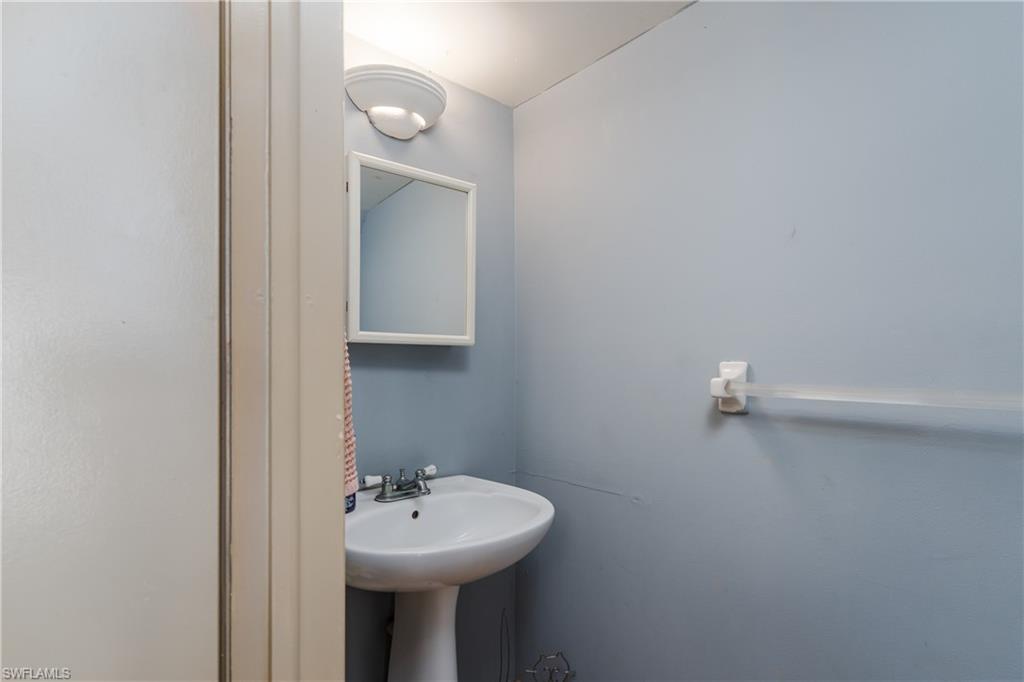 20 Watercolor Way Naples, FL 34113 - Photo 23 of 44 a bathroom with a sink a mirror and vanity