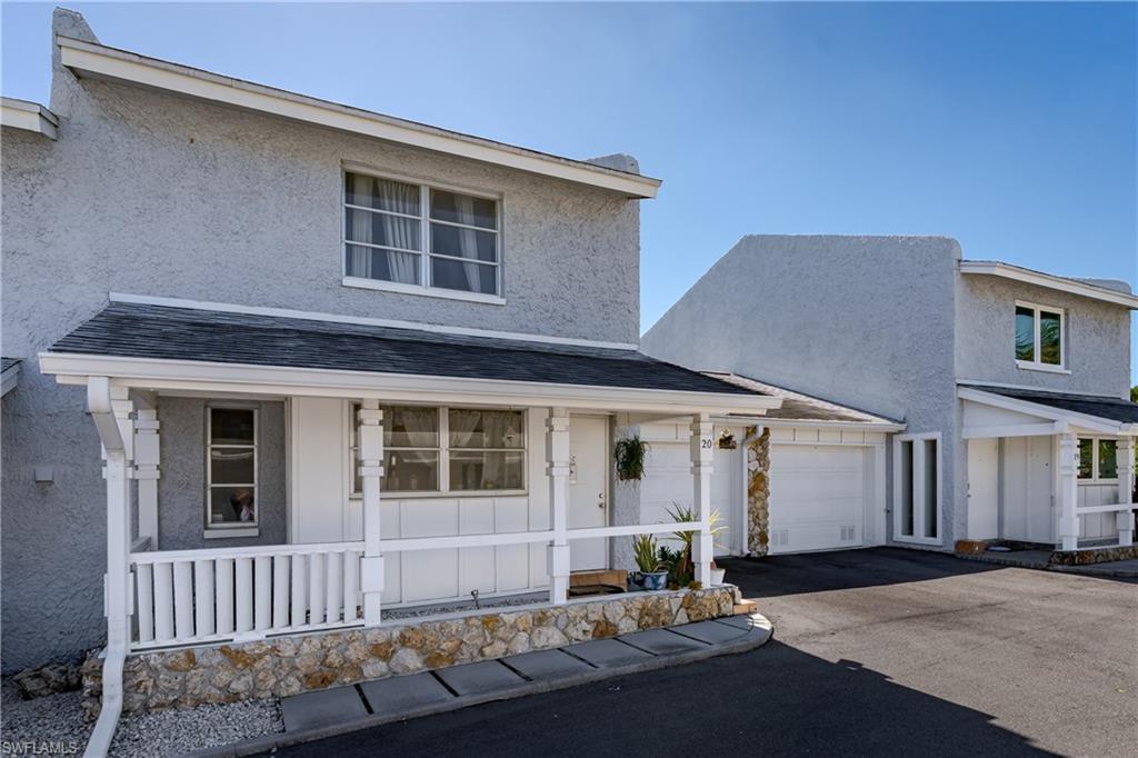 20 Watercolor Way Naples, FL 34113 - Photo 25 of 44 a front view of a house with a yard and garage