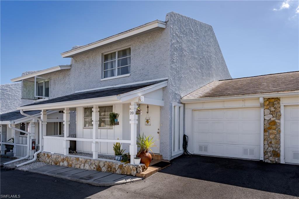 20 Watercolor Way Naples, FL 34113 - Photo 26 of 44 a front view of a house with yard