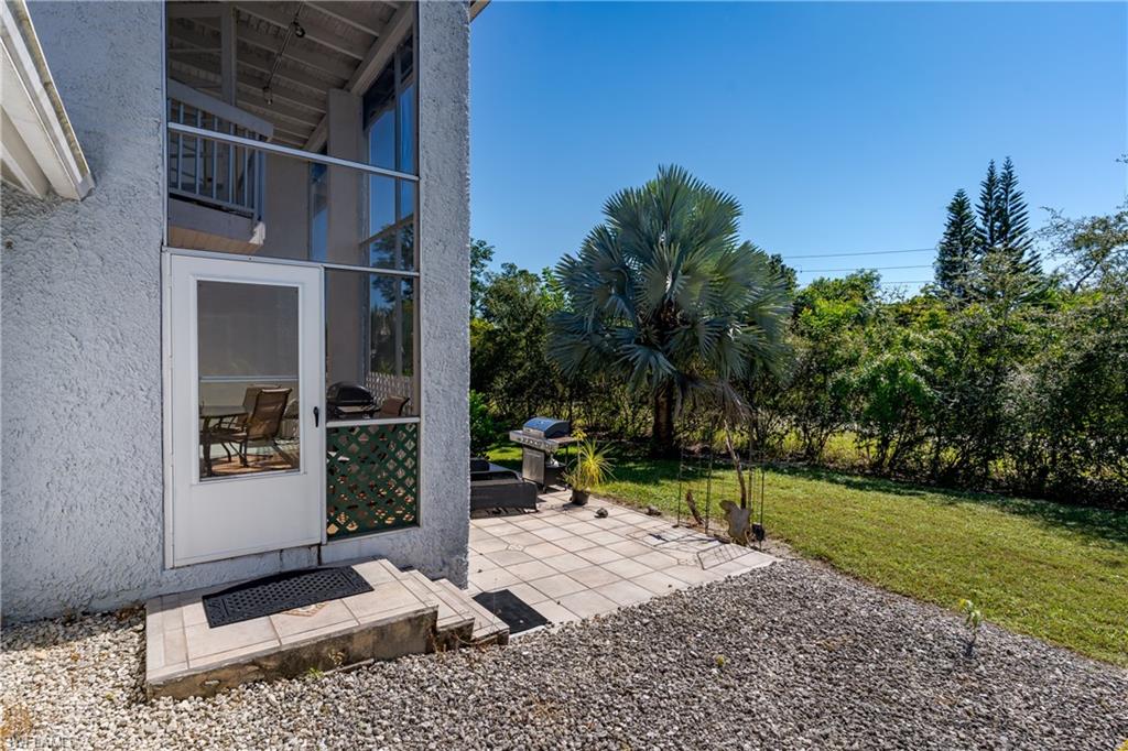 20 Watercolor Way Naples, FL 34113 - Photo 28 of 44 a view of a backyard with sitting area and tree