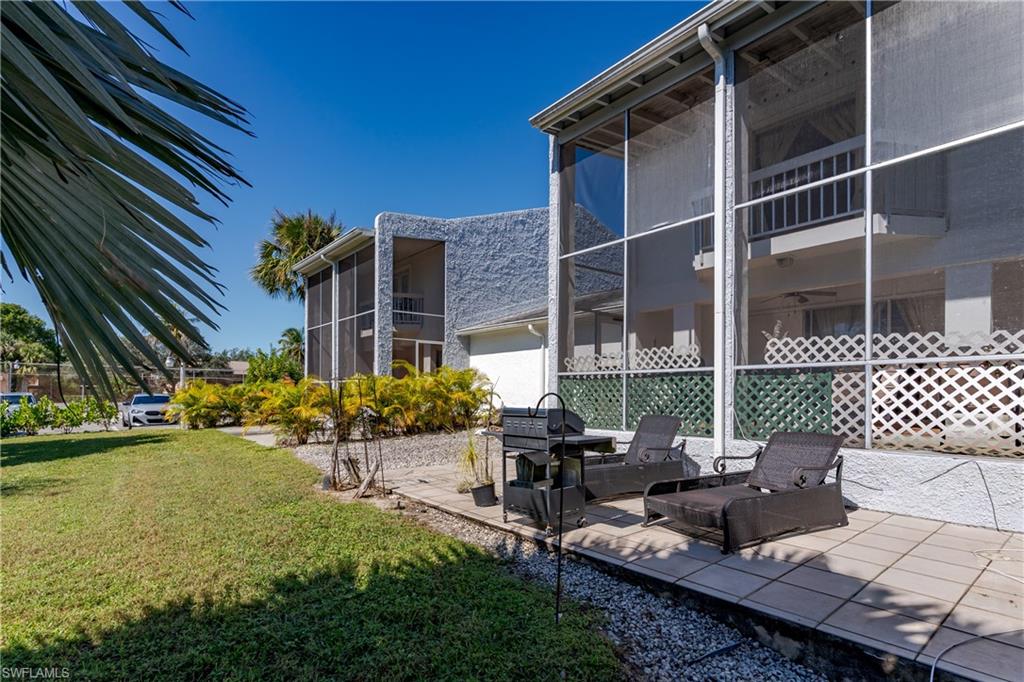 20 Watercolor Way Naples, FL 34113 - Photo 29 of 44 a view of a patio with table and chairs and potted plants