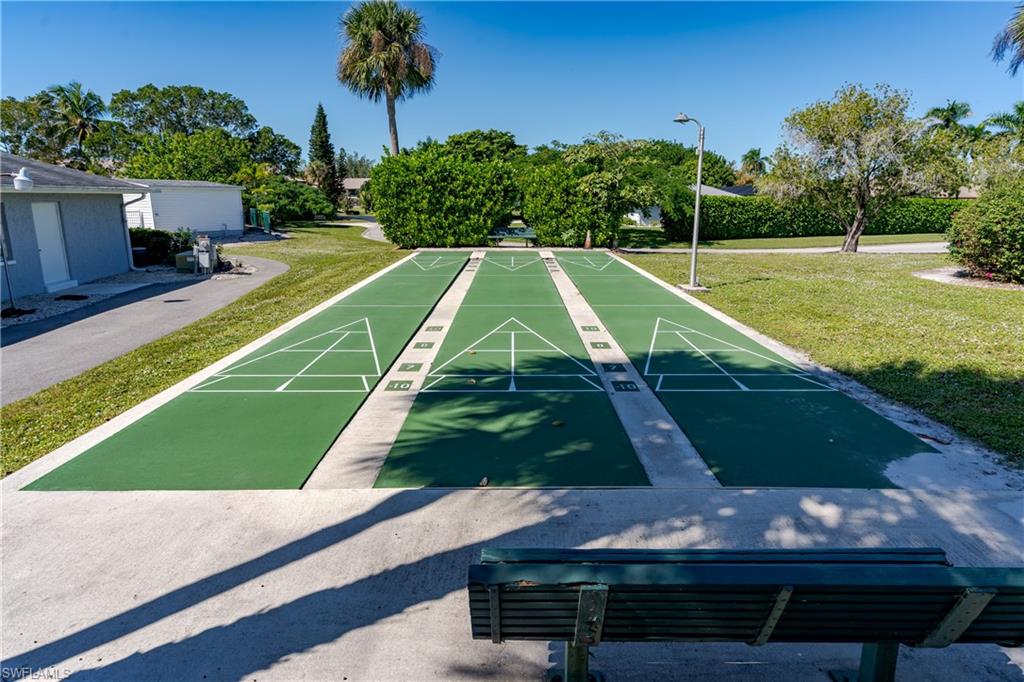 20 Watercolor Way Naples, FL 34113 - Photo 31 of 44 a view of a tennis ground with large trees