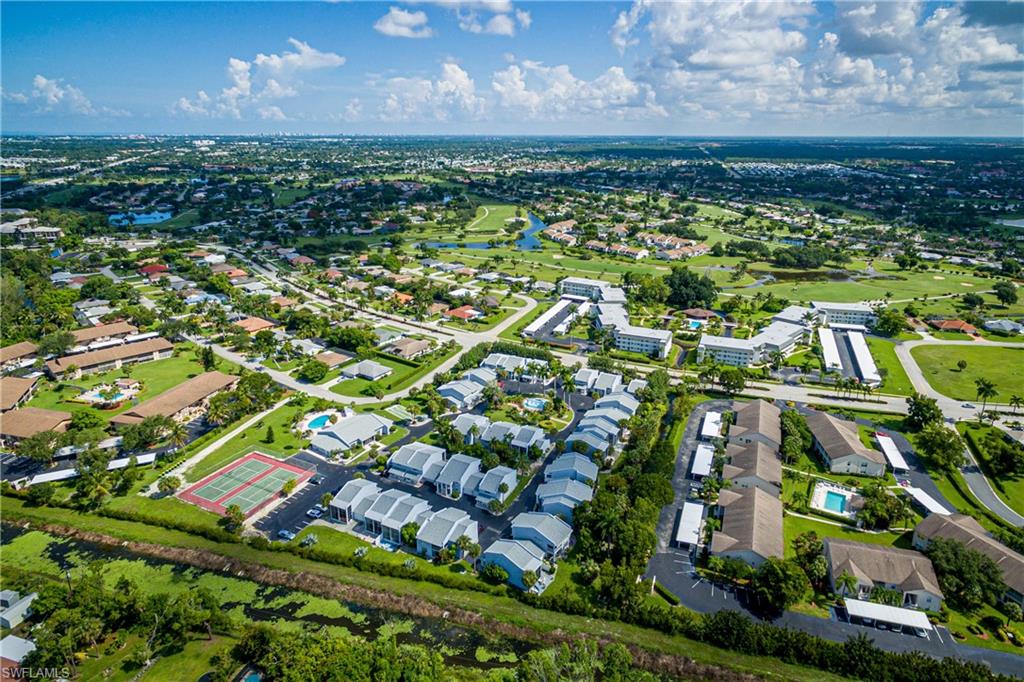 20 Watercolor Way Naples, FL 34113 - Photo 36 of 44 an aerial view of residential houses with outdoor space and trees