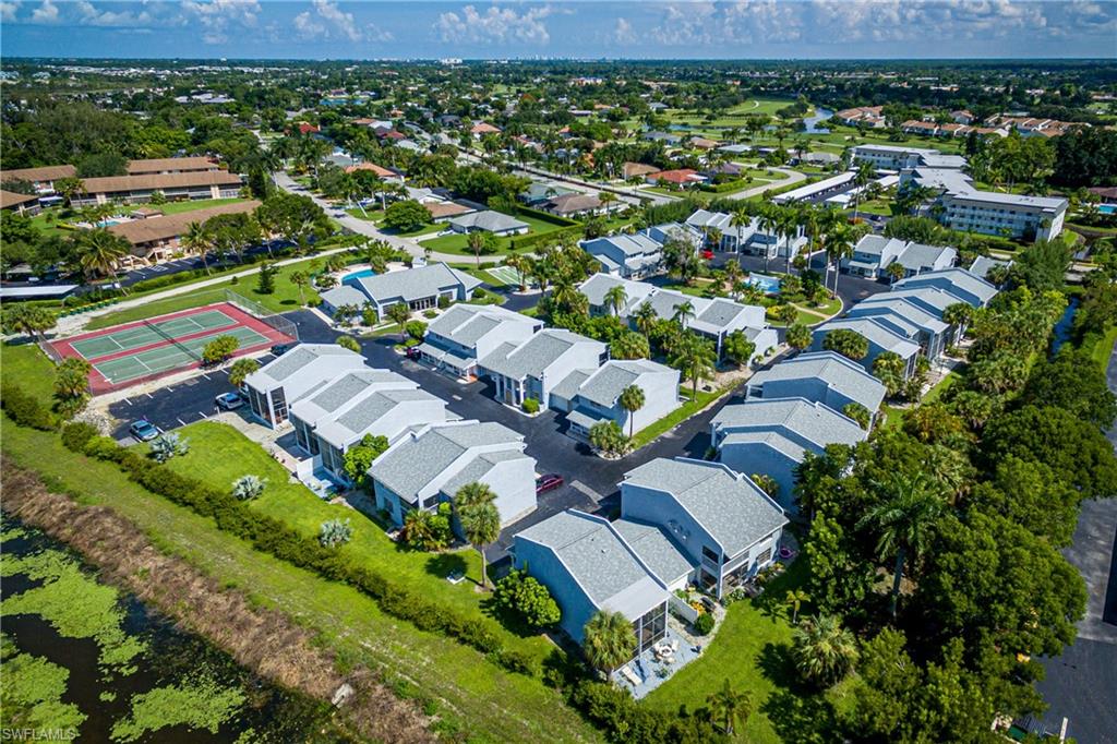20 Watercolor Way Naples, FL 34113 - Photo 41 of 44 an aerial view of residential houses with outdoor space and parking