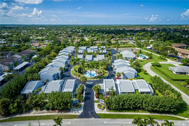 an aerial view of residential houses with outdoor space and river