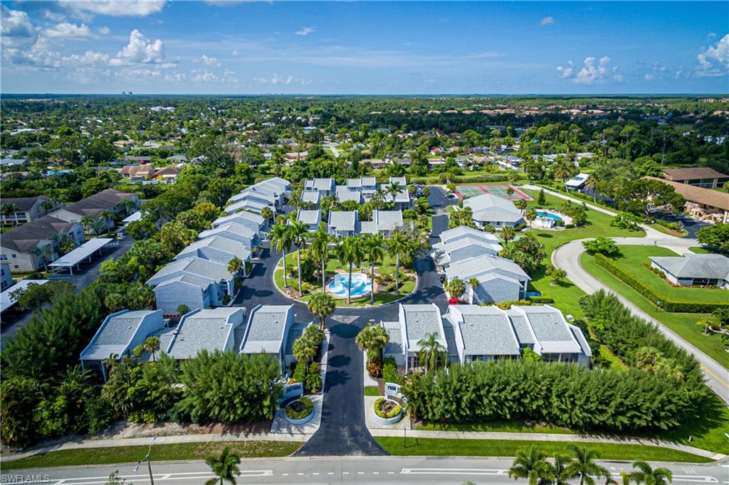 20 Watercolor Way Naples, FL 34113 - Photo 42 of 44 an aerial view of residential houses with outdoor space and trees