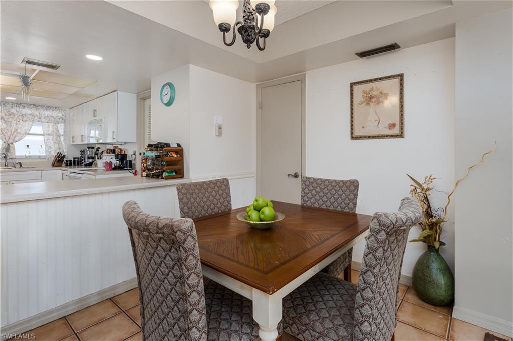20 Watercolor Way Naples, FL 34113 - Photo 10 of 44 a view of a dining room with furniture and chandelier
