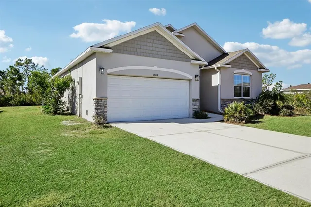 a front view of a house with a yard and garage