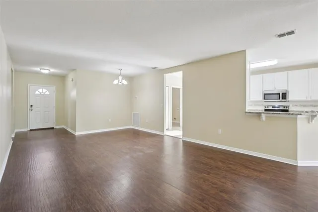 a view of a kitchen with a sink and wooden floor