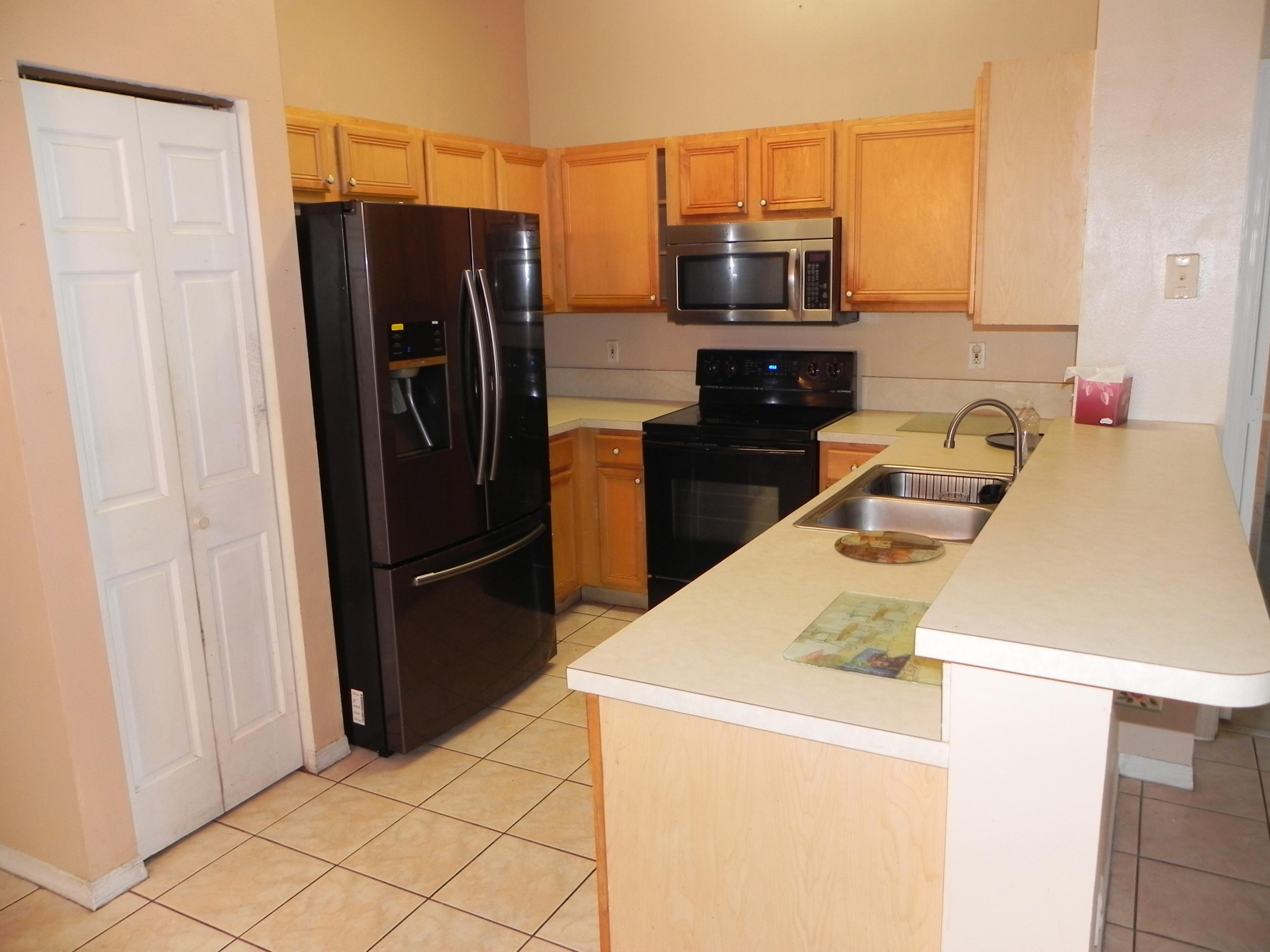 4629 Southwest 12th Street Deerfield Beach, FL 33442 - Photo 13 of 68 a kitchen with a refrigerator and a stove