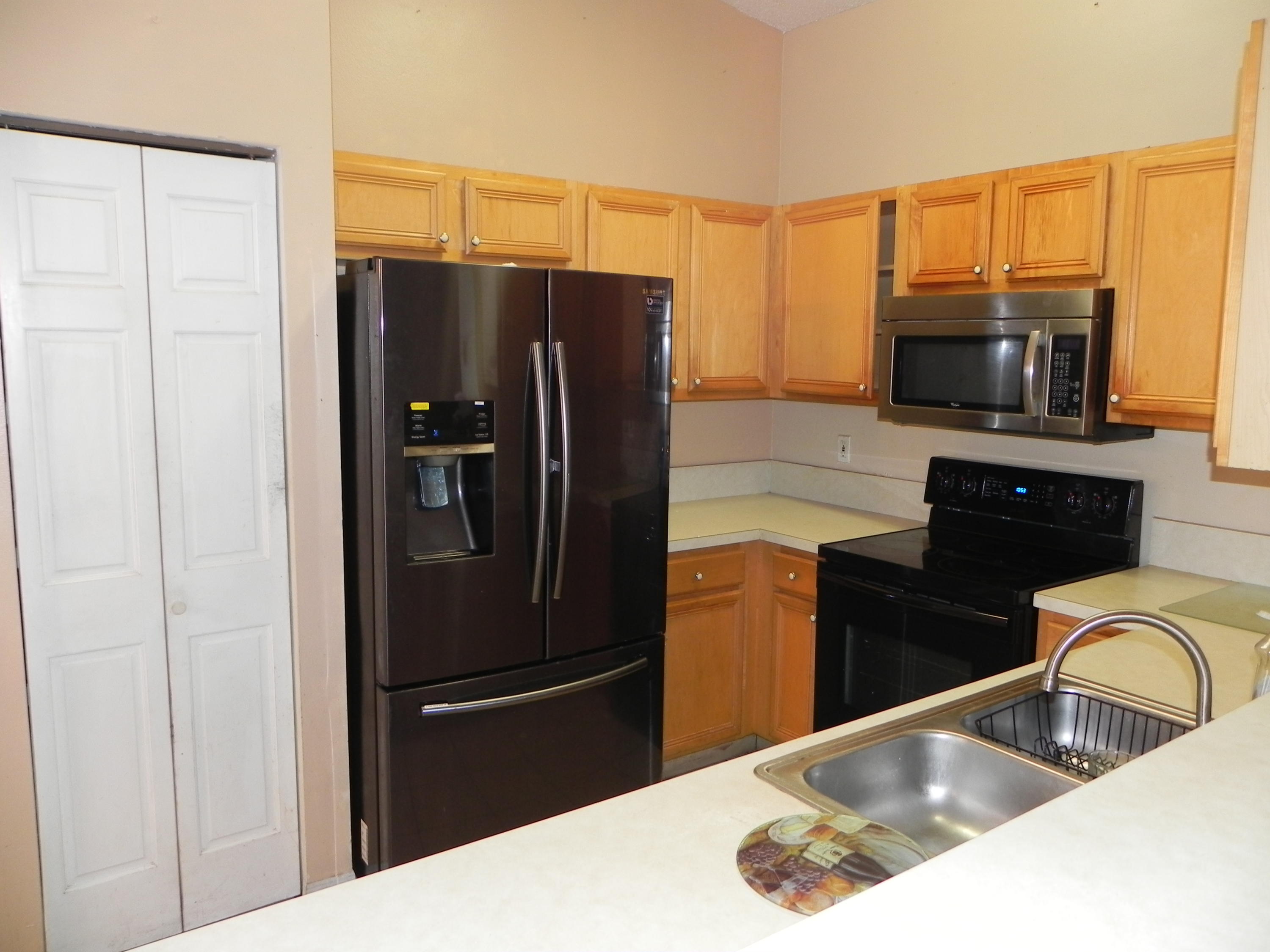 4629 Southwest 12th Street Deerfield Beach, FL 33442 - Photo 14 of 68 a kitchen with a refrigerator sink and microwave
