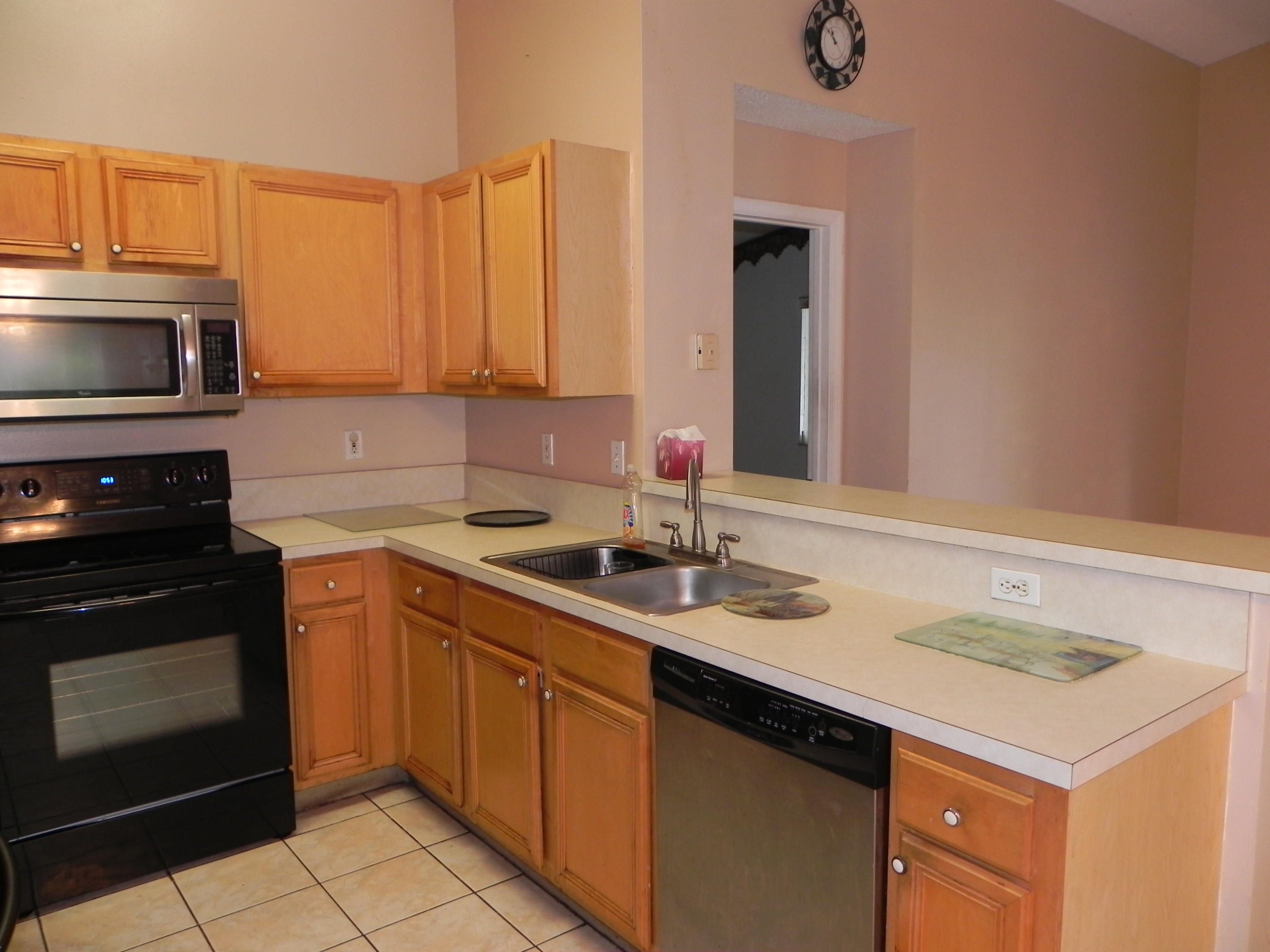 4629 Southwest 12th Street Deerfield Beach, FL 33442 - Photo 15 of 68 a kitchen with a sink stove and microwave