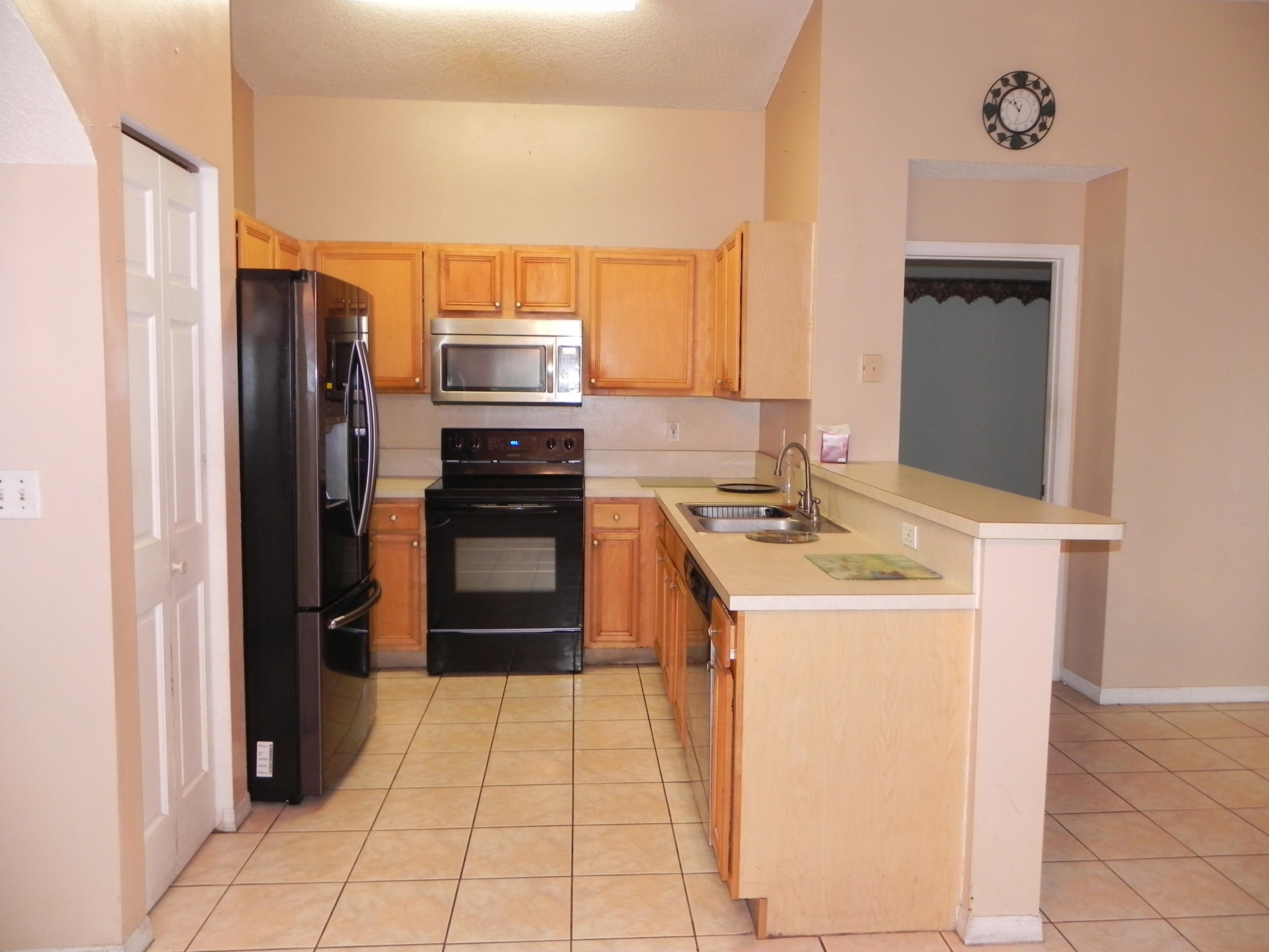 4629 Southwest 12th Street Deerfield Beach, FL 33442 - Photo 16 of 68 a kitchen with a sink stove and refrigerator